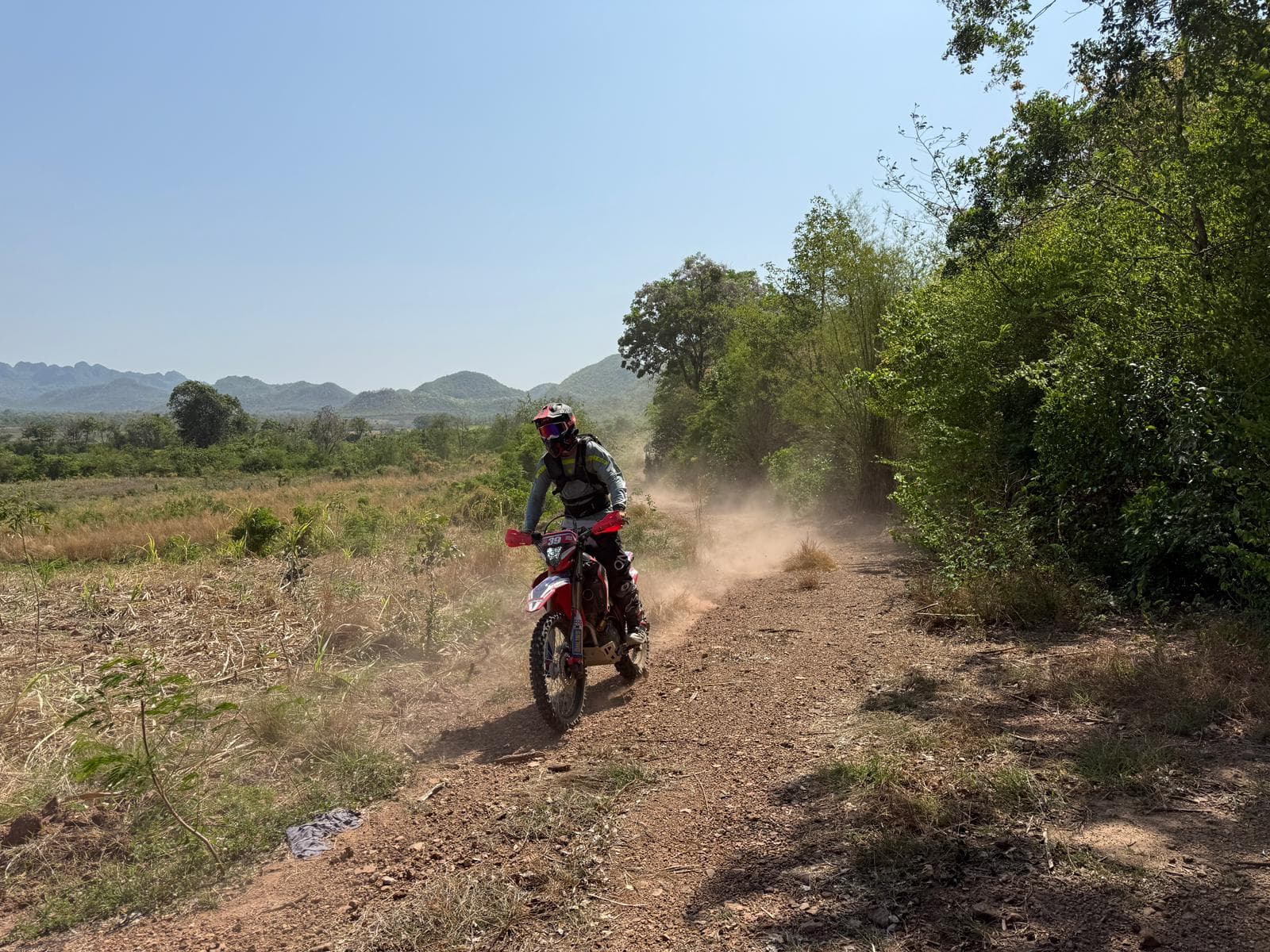 Enduro riders on hillside trail in Thailand
