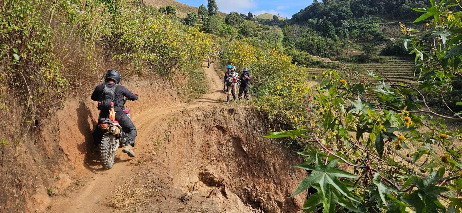 Enduro riders on narrow ridge trail in Eastern Thailand